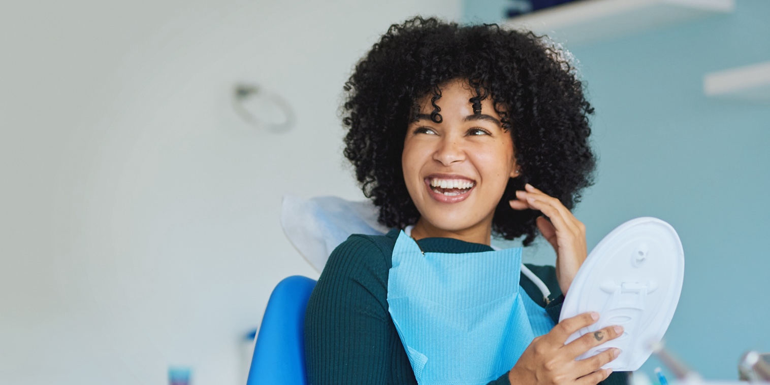 Young woman smiling with at denturist